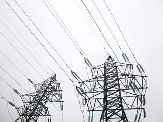 power transmission line poles against the sky