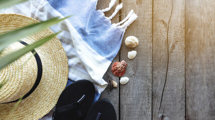 Travel, vacation, weekends concept. Straw hat, palm leaf, shoes, towel, shells