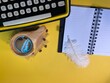 © Józef - there is a typewriter on a yellow background, an ecological pen. Next to it there is a wooden cup with coffee and scattered coffee beans