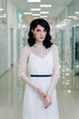 © Alex Li - Brunette girl wearing white designer dress beautiful portrait. Vertical photo in full growth. Sad look.