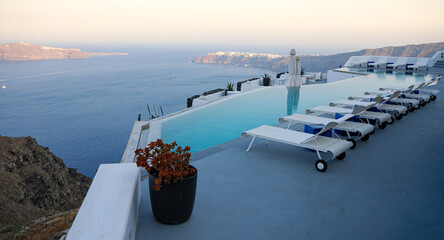 Roof garden of a holiday resort hotel against the ocean at sunset. Oia village, Santorini Island, Greece.