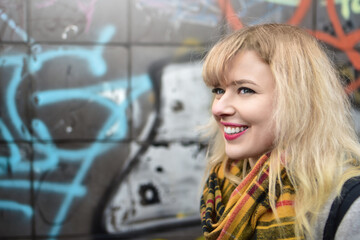 blonde urban teen girl against grafitti wall