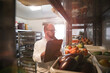 © Connect Images - Chef checking stock of goods in storage room