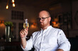 © Connect Images - Portrait of chef with glass of wine in luxury restaurant