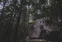 Climber Bouldering In Forest, Squamish, Canada