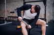 © Connect Images - Young man massaging thigh with muscle roller stick in gym