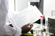 © Connect Images - Young female scientist looking at results in laboratory, cropped