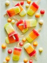 Tri-coloured Ice Lollies And Ice Balls On Table