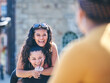 © Connect Images - Young woman getting piggy back from teenage sister, over shoulder view