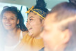 © Connect Images - Young woman with teenage sisters in car back seat laughing, close up