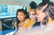 © Connect Images - Young woman and teenage sisters in back seat of car