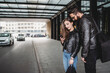 © Connect Images - Couple using smartphone outside station