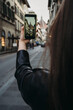 © Connect Images - Woman taking photograph of buildings in city