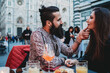 © Connect Images - Man tenderly touching chin of woman in cafe, Santa Maria del Fiore, Firenze, Toscana, Italy