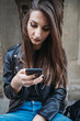 © Connect Images - Woman using smartphone on steps