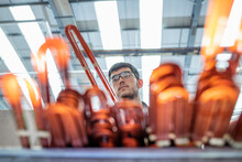 Electrical Engineer Inspecting Copper Windings In Electrical Engineering Factory
