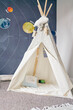 © Connect Images - Child's teepee, mural of solar system on wall