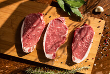 Thick Slices Of Raw Meat, Rosemary, Peppercorn