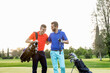 © Connect Images - Friends talking and laughing on golf course
