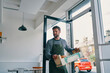 © Connect Images - Man carrying crate of food supply into restaurant
