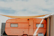 © Connect Images - Exterior view of vintage orange camper van with sun-sail on Fuerteventura.