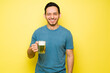 © AntonioDiaz - Latin man making eye contact and smiling with a beer