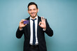 © AntonioDiaz - Latin man smiling after receiving his credit card