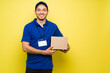 © AntonioDiaz - Hispanic delivery courier wearing a blue uniform
