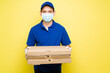 © AntonioDiaz - Latin worker making a food delivery during the covid pandemic