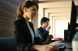 © Connect Images - Businessman and businesswoman working in business centre in hotel