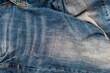 Old faded jeans close-up. Jeans background.