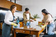 © Marcos - mexican Family mother, son and daughter cleaning kitchen at home in Mexico city