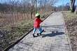 © Eva - little boy rollerblading in a red jacket and yellow bicycle helmet in Budapest suburb, Hungary