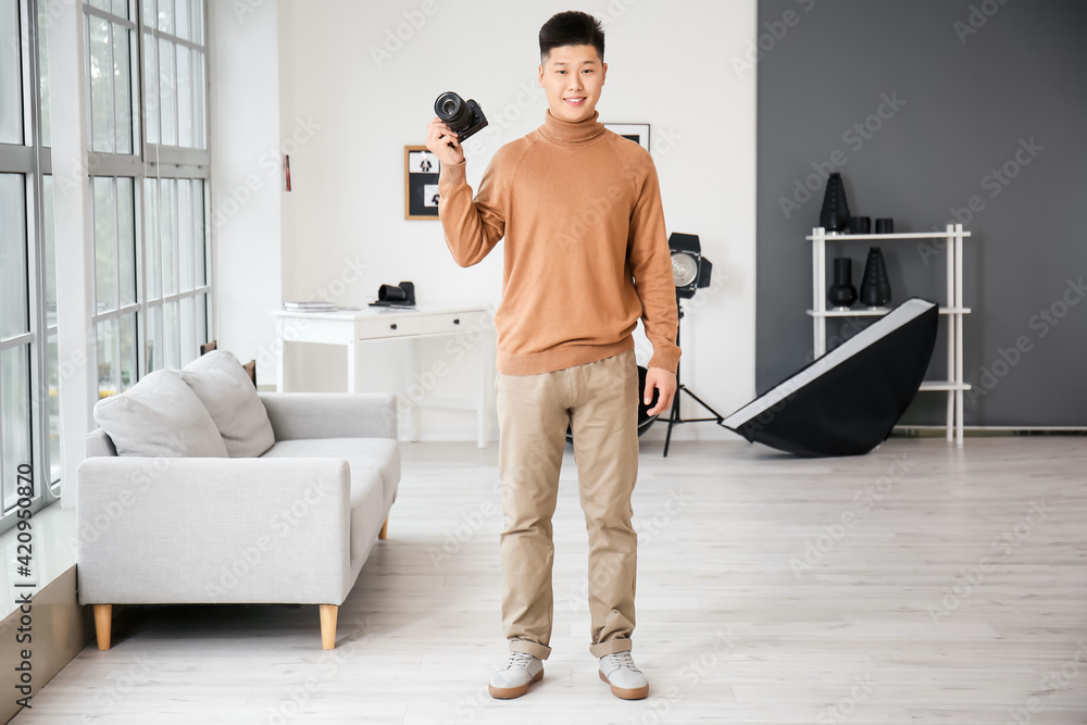 Young Asian photographer in studio