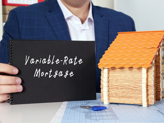 Young woman holding a blank card in hands. Conceptual photo about Variable-Rate Mortgage with written text.