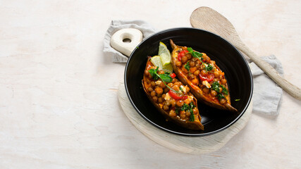 Wall Mural - Stuffed sweet potato with spiced chickpea, dressing and herbs.