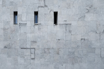 Grey wall with three tall windows