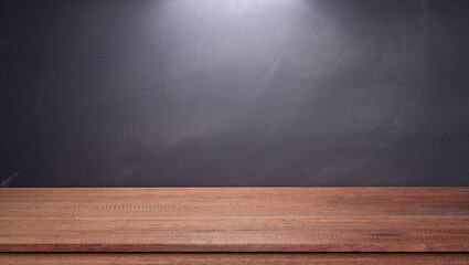 Wall Mural - Wooden table with chalkboard background. 