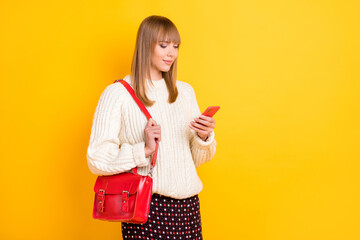 Poster - Portrait of charming lady carry handbag use phone typing post comment isolated on yellow color background