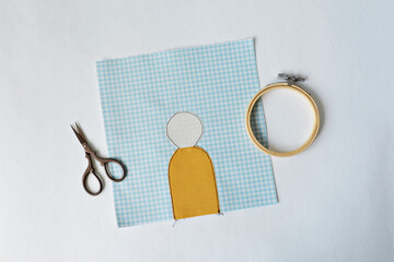 Wall Mural - Working process: applique, scissors and embroidery hoop over white