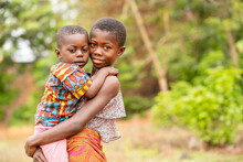 Image Of Beautiful African Siblings, Young Black Girl Carrying A Young Boy- Outdoor Concept
