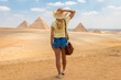 The woman watches the Great Pyramids of Giza in Egypt