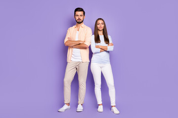 Wall Mural - Full length photo of serious man and woman stand together confident folded hands isolated on purple color background