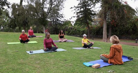 Wall Mural - People doing yoga class keeping social distance at city park - Healthy lifestyle and sport during coronavirus outbreak