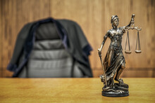 Statue Of Justice And Judge Robe In Courtroom