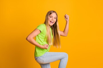 Profile side photo of young girl happy smile celebrate win victory lucky excited fists hands isolated over yellow color background