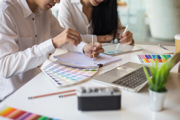 asian men and women mobile application designers build and test new app features. by using the test 