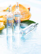 Ampoule with vitamin C for injection and fresh citrus fruits. Natural cosmetics concept. Organic cosmetics.