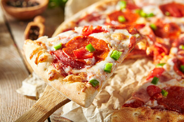 Sticker - Pepperoni pizza with pizza sauce, mozzarella cheese and pepperoni. Pizza on wooden board on wood table with ingredients.