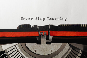 Wall Mural - text never stop learning typed on retro typewriter